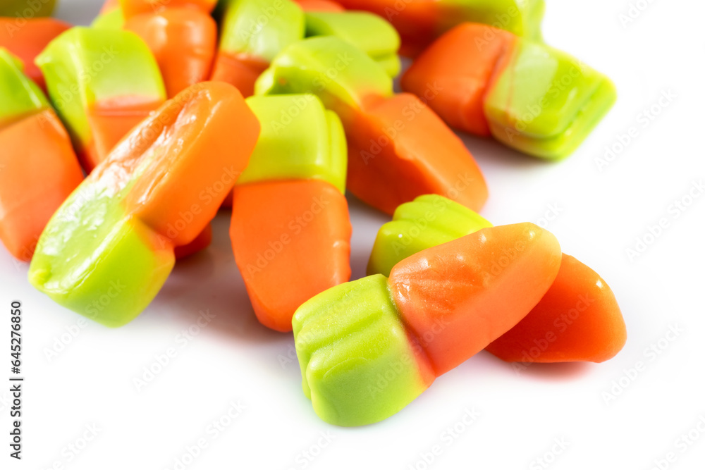 jelly carrots candies on a white background. Colorful fruit gum candies. jelly carrots candies on a white background. Colorful fruit gum candies.