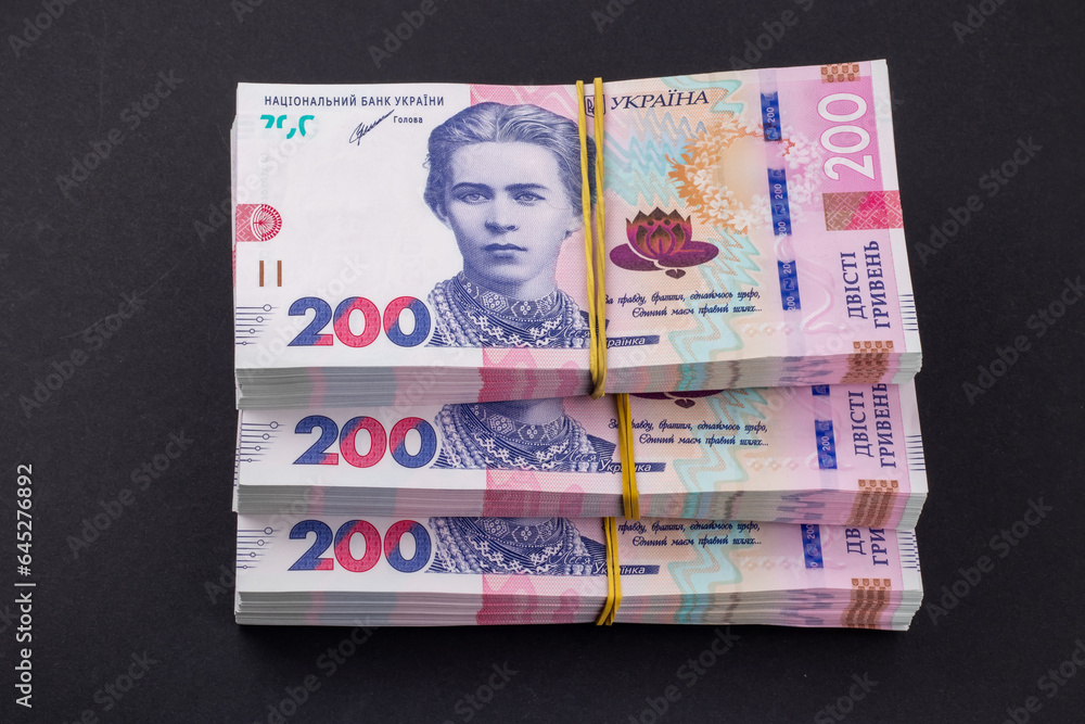 Obraz premium Stack of ukrainian money hryvnia. grivna, hryvna with 200 banknotes
