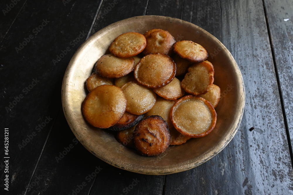 Traditional snacks and sweets of India. It is made by mixing rice flour and jaggery and frying it in oil. Indian holy offerings. It is made during festivals. Indian food. Traditional snacks and sweets of India. It is made by mixing rice flour and jaggery and frying it in oil. Indian holy offerings. It is made during festivals. Indian food.