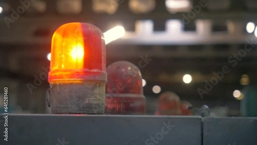 Red warning lamps at a factory. The warning lamp with flickering red light at a cardboard factory. photo