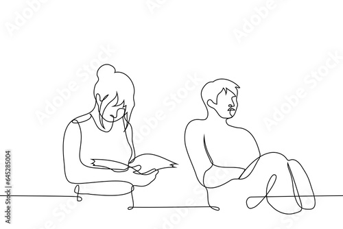 woman reads a book while a man sits and sleeps next to her - one line art vector. concept while one person is studying, the other is sleeping