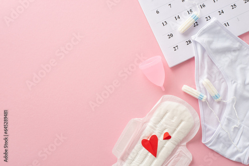 Fényképezés Feminine hygiene supplies like pad with red hearts, symbolizing blood, tampons,
