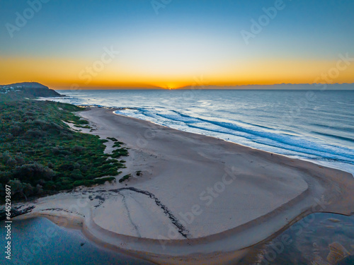 Summer sunrise at the seaside with clouds and haze photo