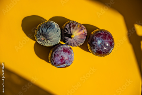 Black fig fruit with yellow background