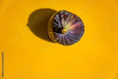 Black fig fruit with yellow background