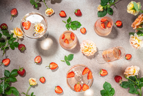 rose wine and strawberries, top view. celebrating background.
