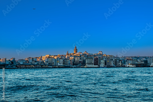 Galata tower and sea and ship in the sunset, Istanbul, Turkey