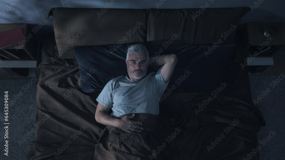 insomnia problem depression,top down view of mature man on bed having trouble sleeping,sleepless overthinking male has difficulties to sleep at night overhead shot