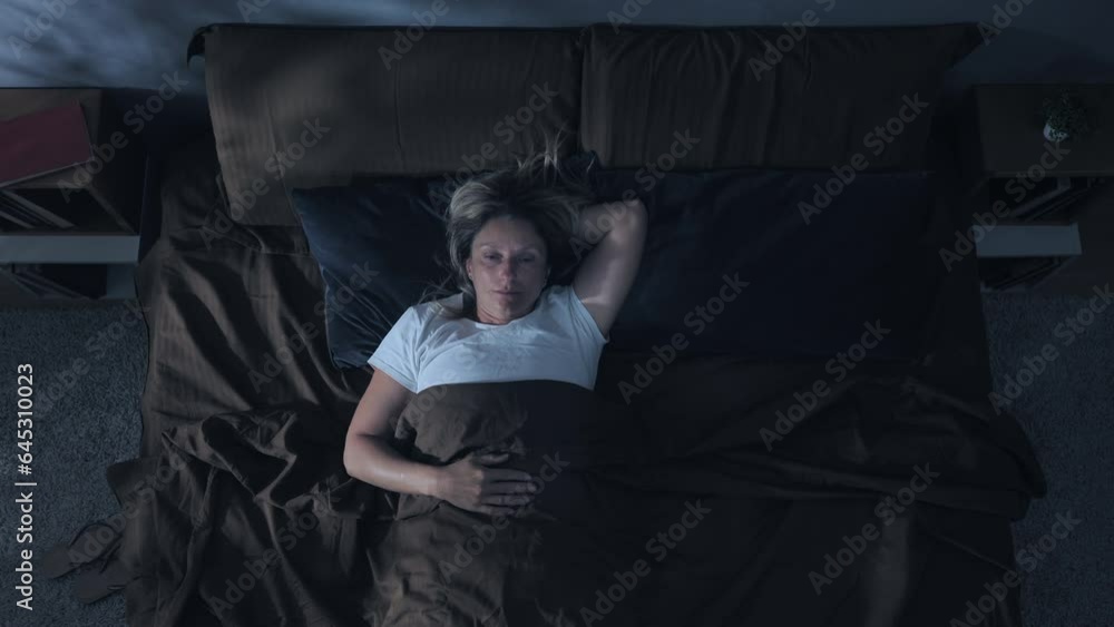 insomnia problem depression,top down view of woman on bed having trouble sleeping,sleepless overthinking female has difficulties to sleep at night overhead shot