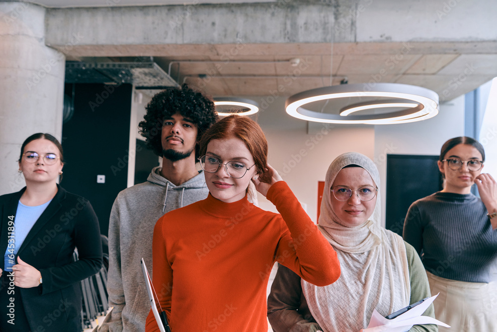 Obraz premium In the sleek corridors of a modern startup office, a diverse group of colleagues, led by their director, confidently stride forward, symbolizing collective success and the journey toward new business