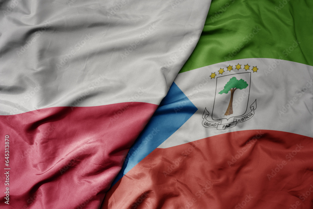 big waving national colorful flag of poland and national flag of equatorial guinea .