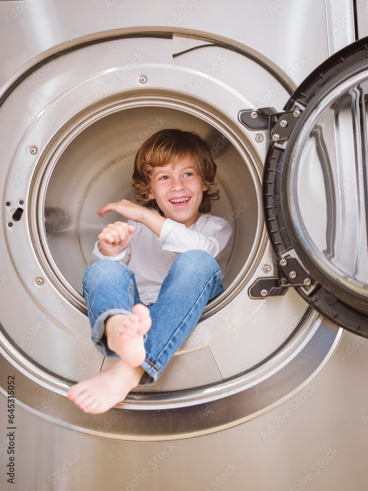 Cheerful boy in washing machine Cheerful boy in washing machine