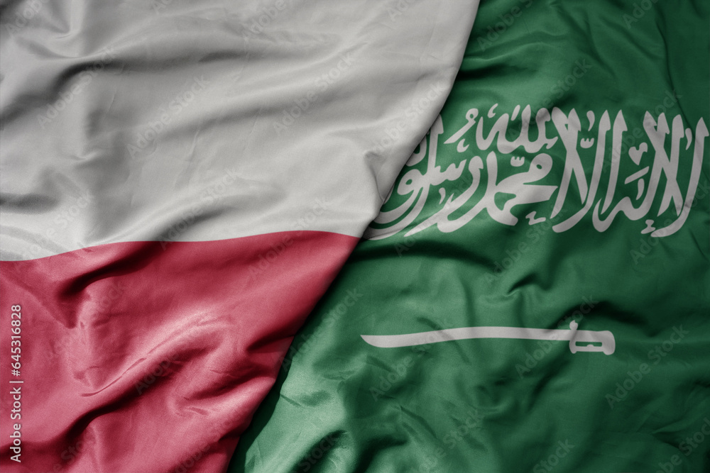 big waving national colorful flag of poland and national flag of saudi arabia .