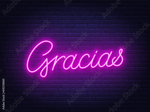 Gracias neon sign on brick wall background.