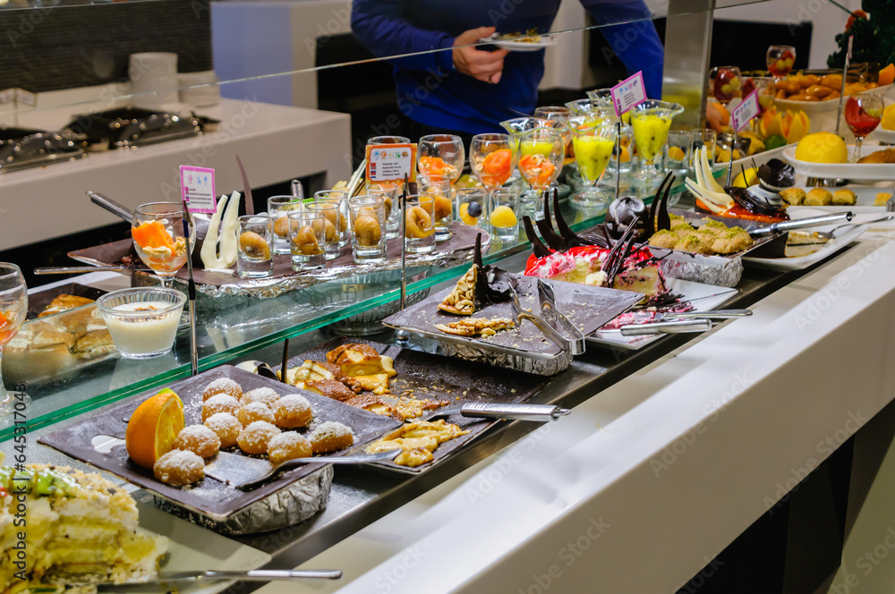 Dessets consisting of cakes, mousses and fruit at the buffet of a hotel restaurant