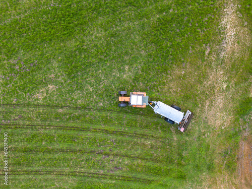 aerial view of tractor , combine cultivating field. drone shot. picture with space for text. Farmland from above. High quality photo