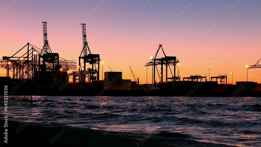 Container Ship Terminal and Cranes in the Evening