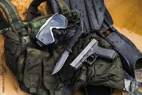 Military diver's equipment, pistol, knife, body armor, fins, mask.