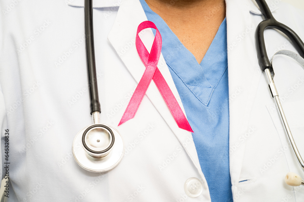 Breast cancer, Asian doctor woman with pink ribbon, symbol of World Breast Cancer Day. Breast cancer, Asian doctor woman with pink ribbon, symbol of World Breast Cancer Day.