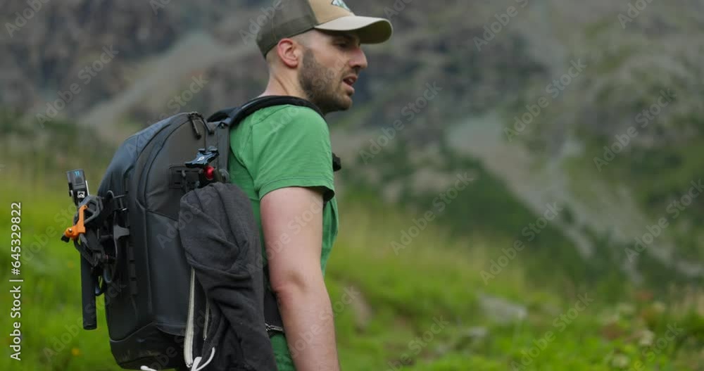 Portrait Of A Hiker With Backpack Trekking On Mountain Trails. Close Up Portrait Of A Hiker With Backpack Trekking On Mountain Trails. Close Up