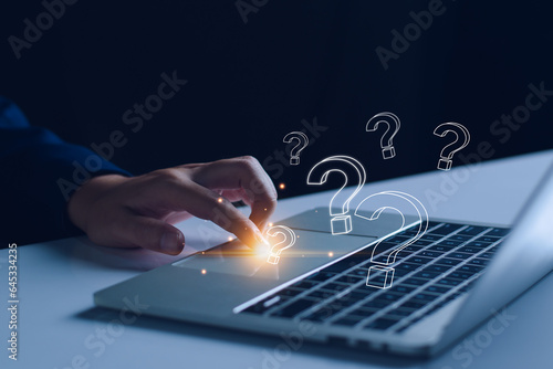 FAQ concept, ask questions, find answer online in customer support. Business man use tablet answering customer questions online, Q&A. Online service gives quick answers.