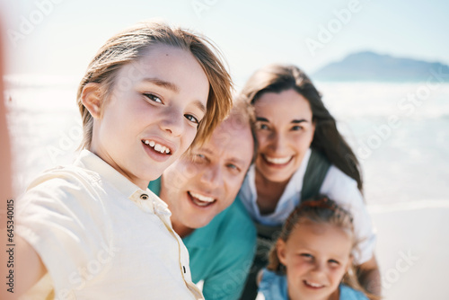 Parents, kids and beach selfie with smile, portrait or care with bonding, love and sunshine on vacation memory. Mom, father and children by sea, waves or social media on holiday for summer in Spain