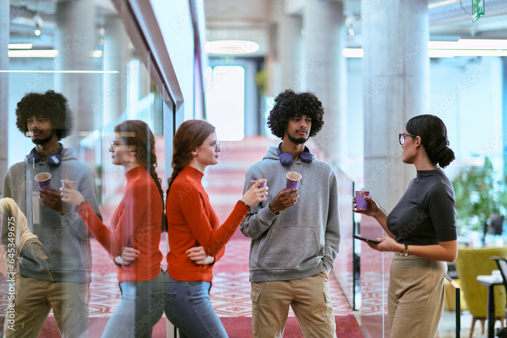 Amidst the modern glass walls of a startup office, a diverse group of colleagues, including an African American man, engage in a coffee-fueled discussion, exemplifying collaboration and innovation in Amidst the modern glass walls of a startup office, a diverse group of colleagues, including an African American man, engage in a coffee-fueled discussion, exemplifying collaboration and innovation in