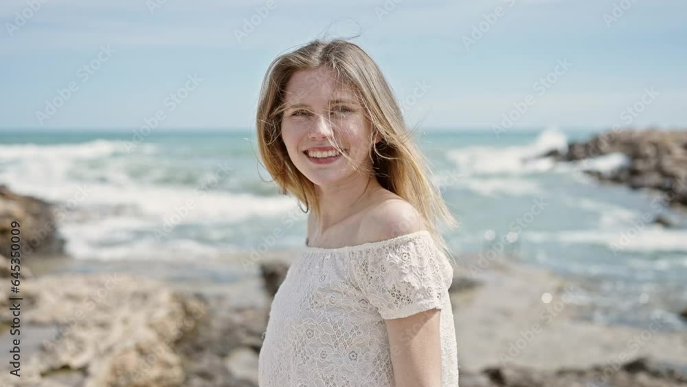 Young blonde woman tourist smiling confident standing at beach Young blonde woman tourist smiling confident standing at beach