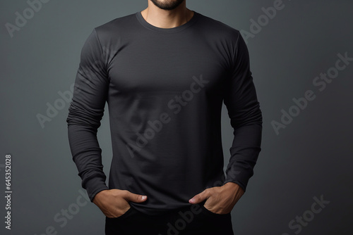 man wearing black long sleeve tshirt against gray background