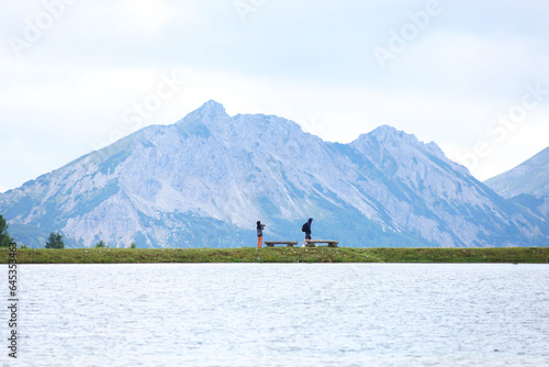Couple walk in beautiful landscape with background mountains trees © Olga