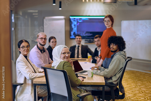 A diverse team of business experts in a modern glass office, attentively listening to a colleague's presentation, fostering collaboration and innovation.