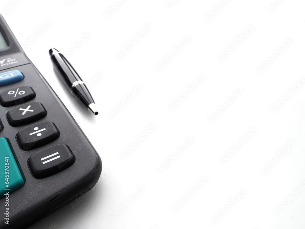 Financial or educational background with a black calculator and a pen and copy space to write text Financial or educational background with a black calculator and a pen and copy space to write text