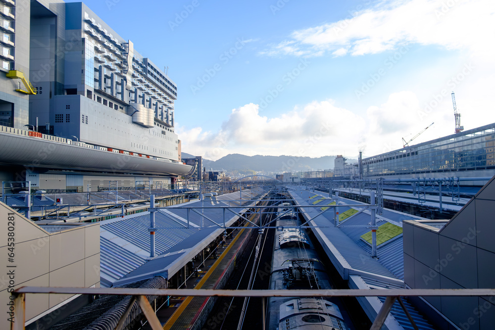 the grandeur of Kyoto Station, where a captivating row of roofs stretches along the train platform. 