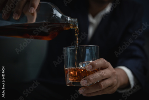 alcoholism alcohol addiction and people's ideas Alcoholic man with flask and drinking whiskey at home, businessman in luxury suit with glass of whiskey Elegant drink concept