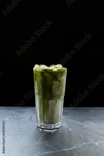 Matcha, Japanese green tea, mixed with milk, cold drink, ice, cafe menu, health, on a black background