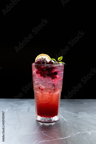 Berry juice, blueberry, blackberry, mixed berry, lemon, mint, ice, cold drink Italian soda, sparkling on a black background