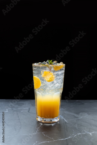 fruit juice cold orange juice freshly squeezed orange flesh orange ice clear glass black background beverage cafe cocktail mocktail