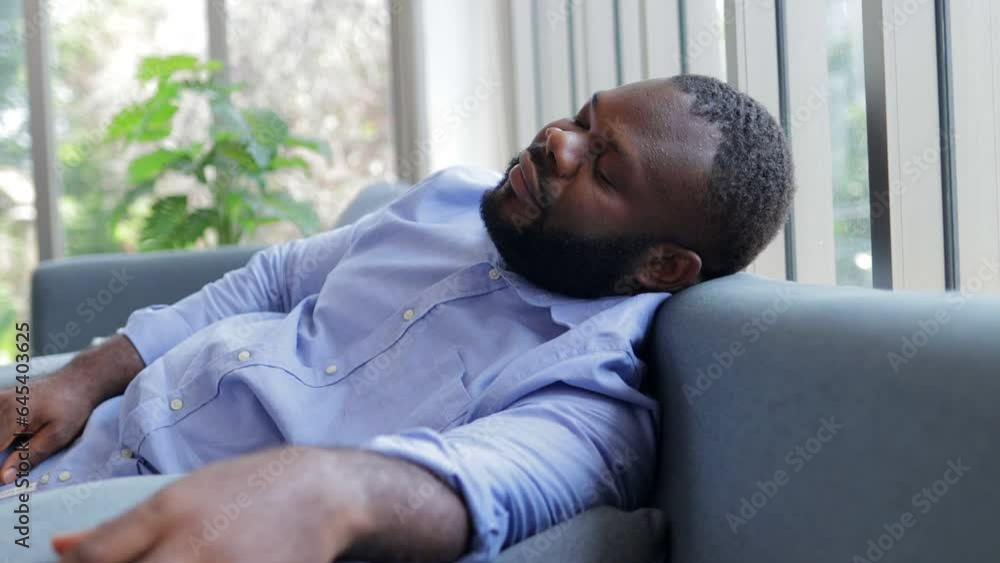 African American man sleeping on the sofa in the house. restful sleep African American man sleeping on the sofa in the house. restful sleep