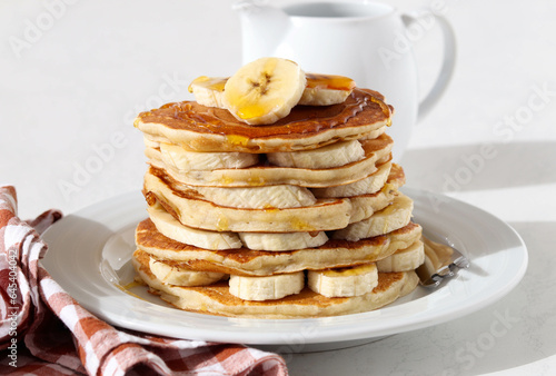 Pile of banana pancakes with honey