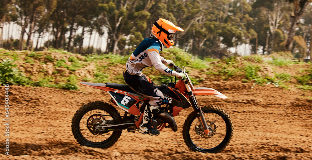Motorcycle, training and speed with a sports man on space in the forest for dirt biking. Bike, fitness and power with a person driving fast on an off road course for freedom, challenge or performance Motorcycle, training and speed with a sports man on space in the forest for dirt biking. Bike, fitness and power with a person driving fast on an off road course for freedom, challenge or performance