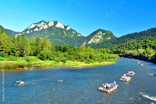 Summer landscape of Pieniny mountains. Traditional rafting on the Dunajec River on wooden boats. The rafting is very popular tourist attraction in Pieniny National Park photo