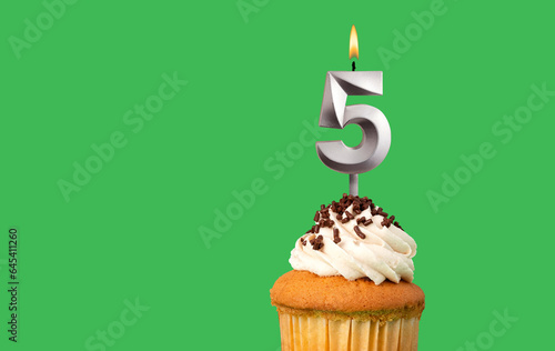 Birthday with number 5 candle and cupcake - Anniversary card on green color background