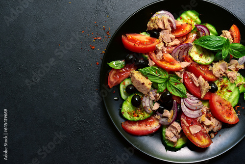 Tuna salad with cucumber and tomato. Top view with copy space.