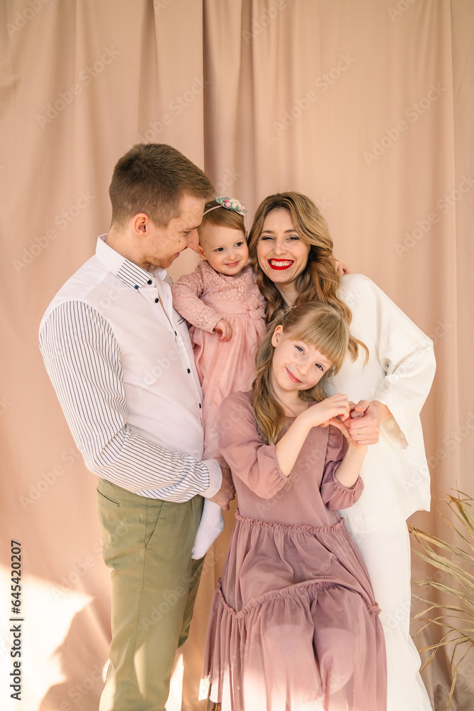 happy family of four father with mother and two daughters