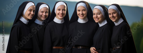 Portrait of a group of nuns against the background of a church