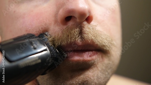 Man Shaving Mustache With Electric Trimmer Close Up