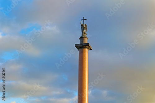 Alexander Column near the Winter Palace in Saint Petersburg  Russia. A monument with a sculpture of an Angel holding a cross against a blue sky with clouds
