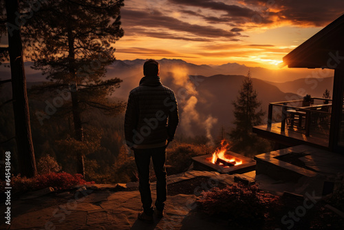 A person captures the stunning sunset view from a co-owned mountain retreat, underscoring the unique experiences facilitated by fractional ownership. Generative Ai.