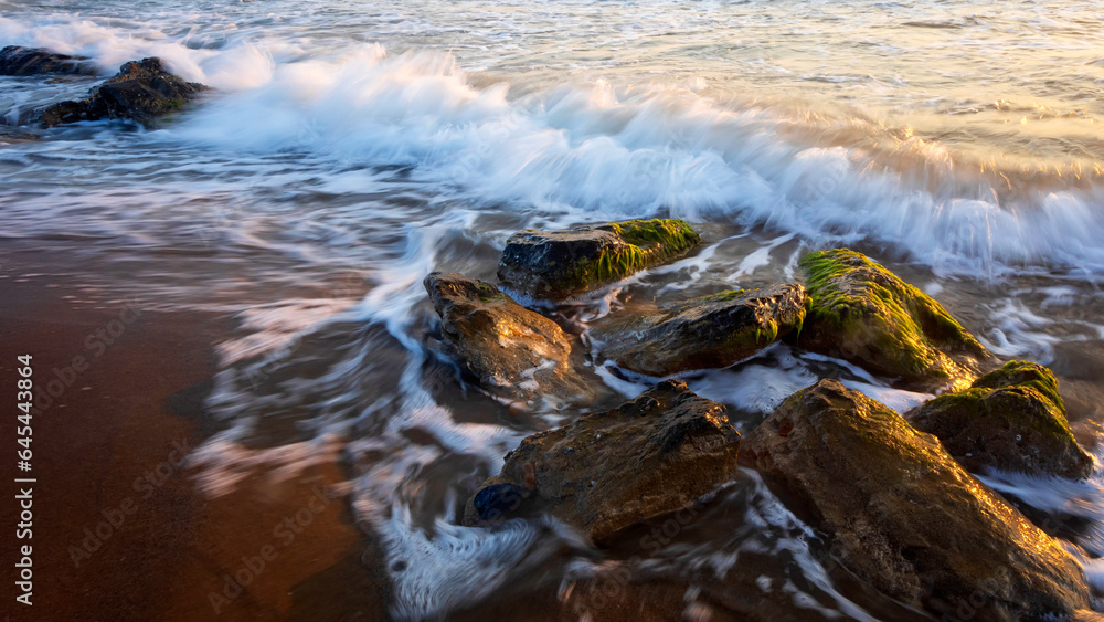Sunset and sea rocks. Photo taken with the long exposure technique. Sunset and sea rocks. Photo taken with the long exposure technique.