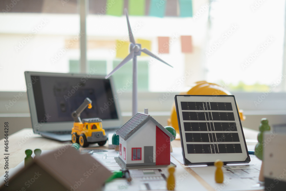 Foto de On desk of engineers lay model of house And solar panels to use